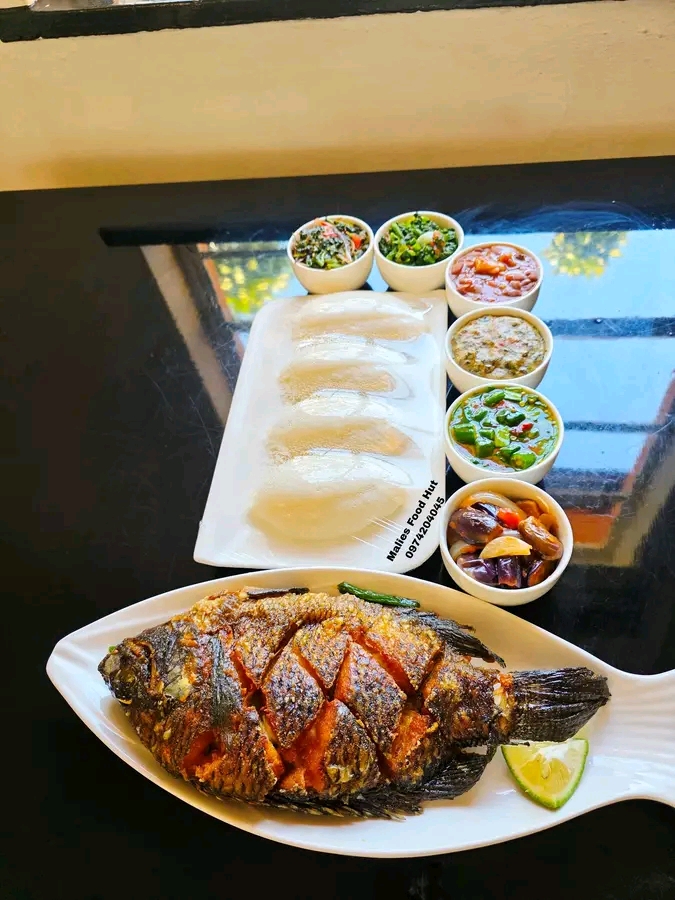 Grilled fish with sides at Malies Food Hut