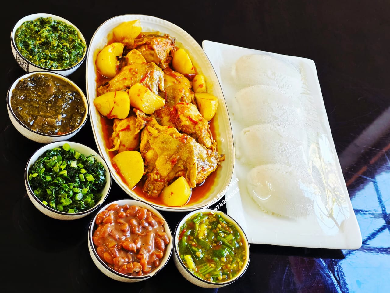 Chicken and potato stew with nsima and sides